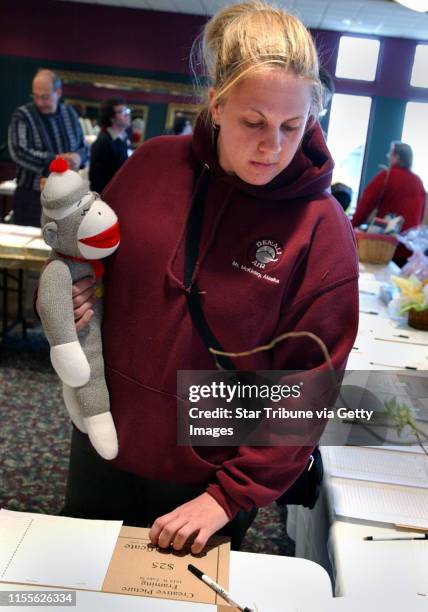Minneapolis, Mn.,Sat.,April 3, 2004--Jenny Lenz of Minneapolis picked up a sock monkey at the Early Bird Extravaganza, a fund raising event for the...