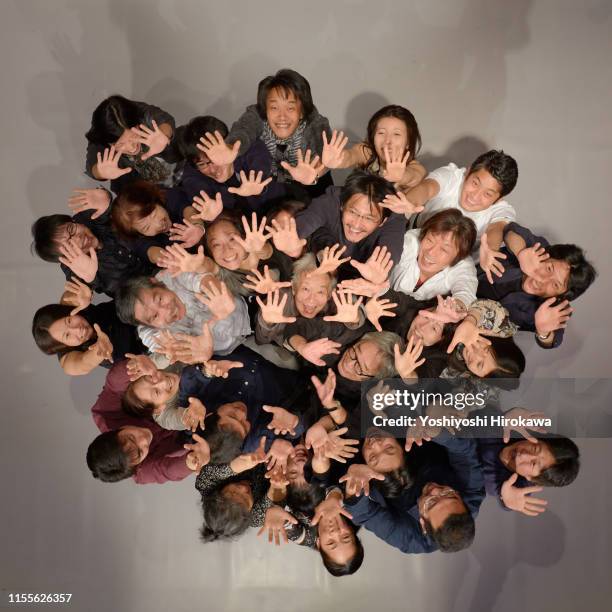 smiling crowd raising arms looking up at the theater from above - female actors stock pictures, royalty-free photos & images