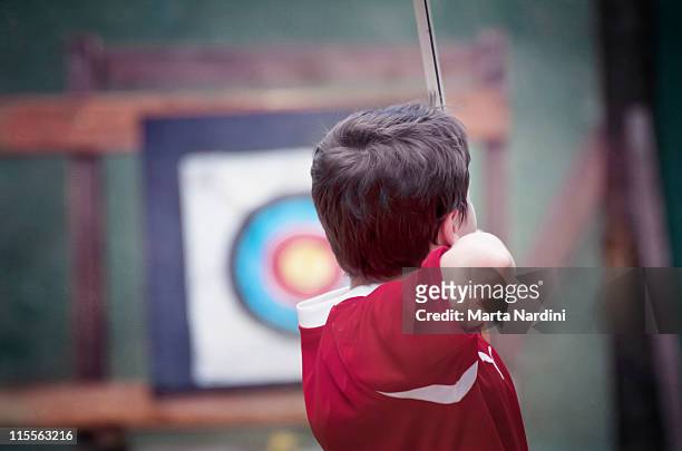 boy practicing archery - archer stock pictures, royalty-free photos & images