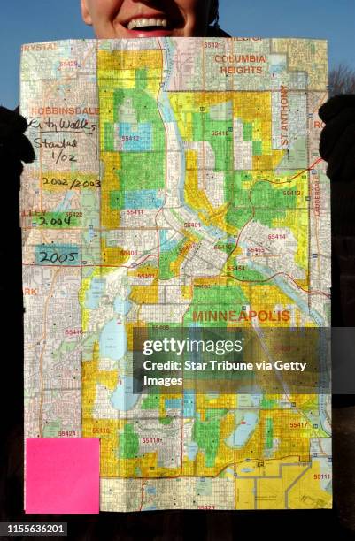 Joey McLeister/Star Tribune Minneapolis,Mn.,Sat.,Feb. 12, 2005--Francine Corcoran holds her color-coded Minneapolis street map that shows the ground...