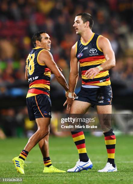 Taylor Walker of the Adelaide Crows celebrates a goal with Eddie Betts of the Adelaide Crows during the round 13 AFL match between the Adelaide Crowd...