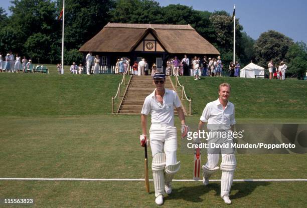Cricket journalist and broadcaster Christopher Martin-Jenkins walking out to bat during a charity cricket match at Wormsley Park, 24th May 1992.