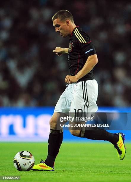 Germany's midfielder Lukas Podolski plays the ball during the Euro 2012 qualifier football match Azerbaijan vs Germany on June 7, 2011 in Baku,...