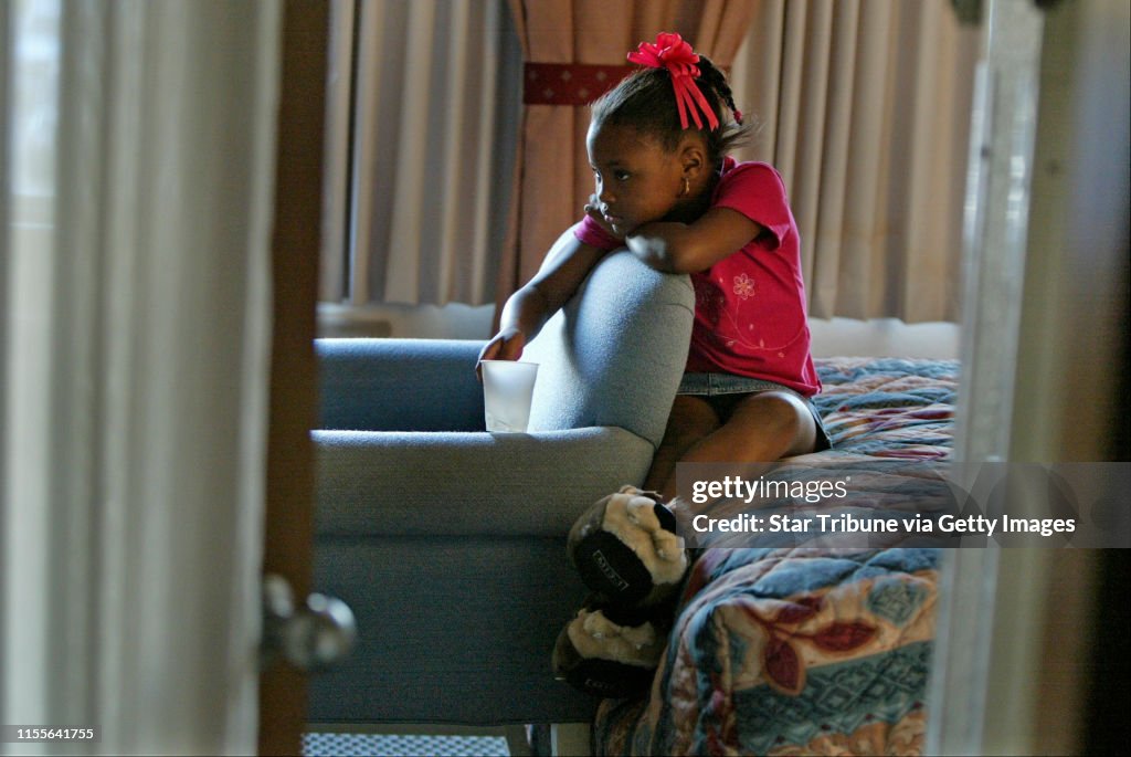 Coon Rapids, MN 9/8/2005--7 yr. old Laundrell Jones watches TV in the the bedroom of the hotel room the family is staying in...waiting for her parents to return from and all afternoon shopping trip. At 8PM Laundrell compalined of being very hungry and ake