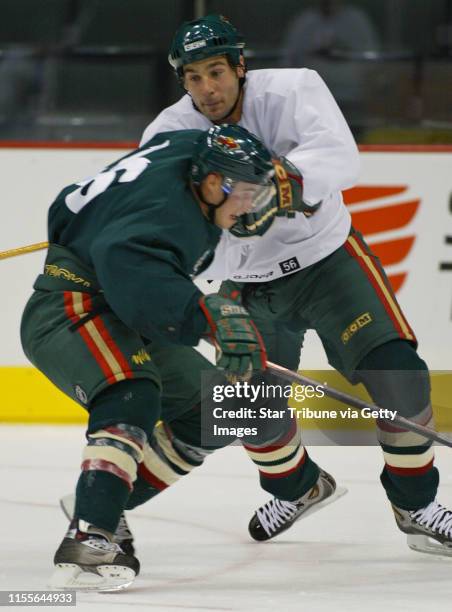Bruce Bisping/Star Tribune. St. Paul, MN., Wednesday, 9/14/2005. Pierre-Marc Bouchard and Ryan Stokes tangled during the afternoon session of the...