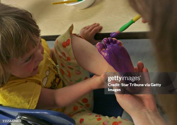 Sgreener@startribune.com 5/9/2006 Coon Rapids, MN.--Especially for Children day care center young pre-schoolers deshoed themselves to feet paint. The...