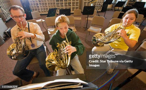 Dbrewster@startribune.com Thursday_10/30/08_Crystal FAIR School Band director Todd Boyd works with two students, Sam Loben and Annika Leitch-Lodge ,...