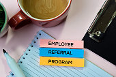 Employee Referral Program text on sticky notes with office desk concept