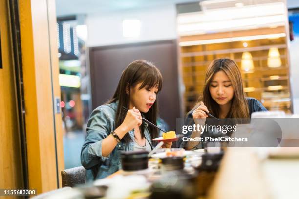 girlfriends eating local food with chopsticks - taiwanese stock pictures, royalty-free photos & images