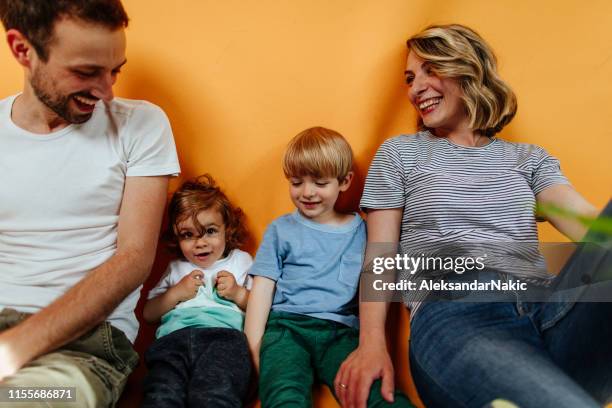 studio portrait of happy family - family on coloured background stock pictures, royalty-free photos & images