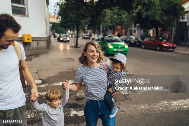 through the city with our boys - couple crossing street stock pictures, royalty-free photos & images