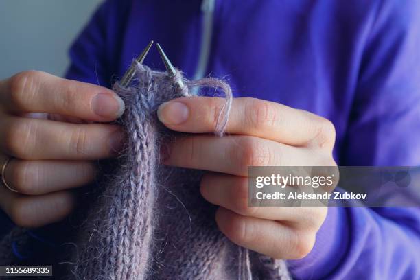 the woman knits woolen clothes. knitting needles. close-up. natural wool - かぎ針編み ストックフォトと画像