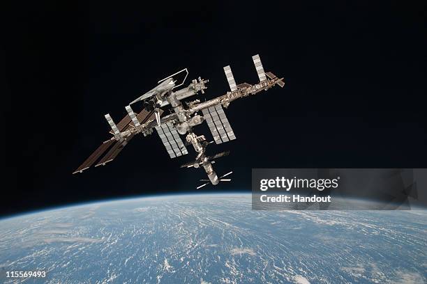 In this handout image provided by the European Space Agency and NASA, the International Space Station and the docked space shuttle Endeavour orbit...