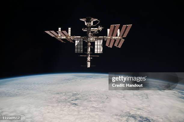 In this handout image provided by the European Space Agency and NASA, the International Space Station and the docked space shuttle Endeavour orbit...