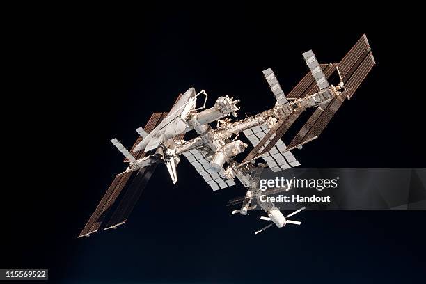 In this handout image provided by the European Space Agency and NASA, the International Space Station and the docked space shuttle Endeavour orbit...