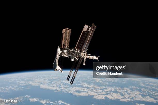 In this handout image provided by the European Space Agency and NASA, the International Space Station and the docked space shuttle Endeavour orbit...