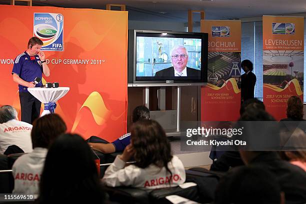 Attendees watch a video message by Theo Zwanziger, President of the German Football Association , on a screen during a welcome event as part of the...