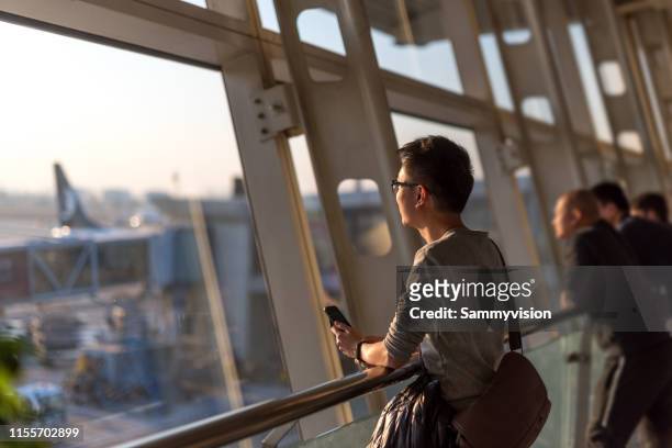 a man waiting for the flight at the terminal - shandong province stock pictures, royalty-free photos & images