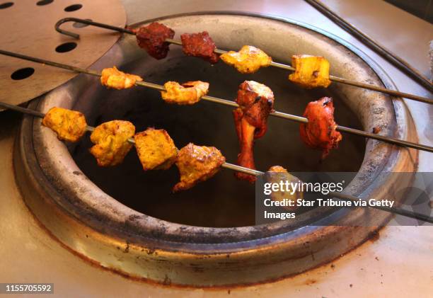 Bbisping@startribune.com Minneapolis, MN., Thursday, 12/2/10] Chicken grilling on the tandoor grill at the Darbar India Grill on West Lake Street.