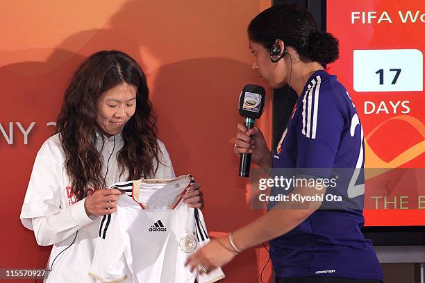 Japan Women's National Soccer Team player Homare Sawa receives a uniform from Steffi Jones, President of the Women's World Cup 2011 German Organizing...