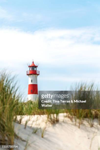 lighthouse on the beach of sylt. "ellenbogen" - ellenbogen stock pictures, royalty-free photos & images