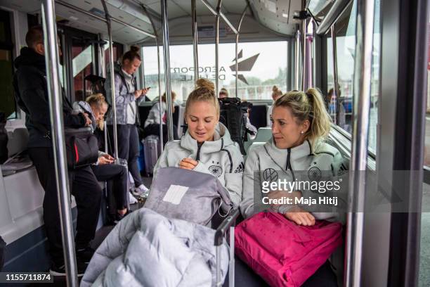 Leonie Maier and Verena Schweers wait on a bus prior a flight from Lille to Montepellier on June 13, 2019 in Montpellier, France.