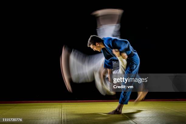 blurred judo throw - judo stock pictures, royalty-free photos & images