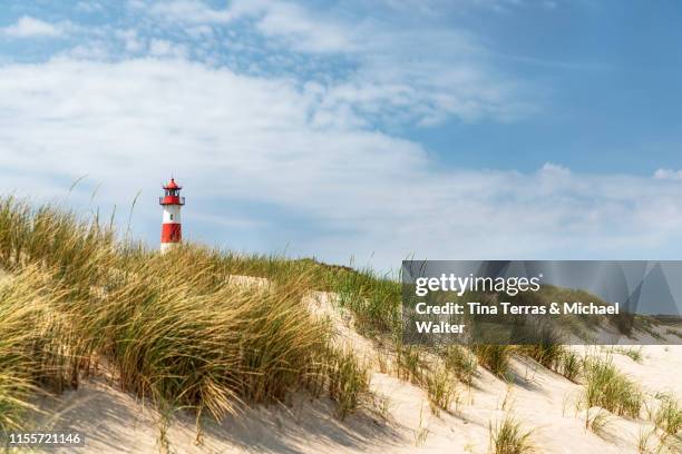 lighthouse on the beach of sylt. "ellenbogen" - german north sea region stock pictures, royalty-free photos & images