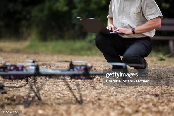 Man prepares a drone with a laptop on a field for experimentation of 5G in agriculture on June 28, 2019 in Koellitsch, Germany.