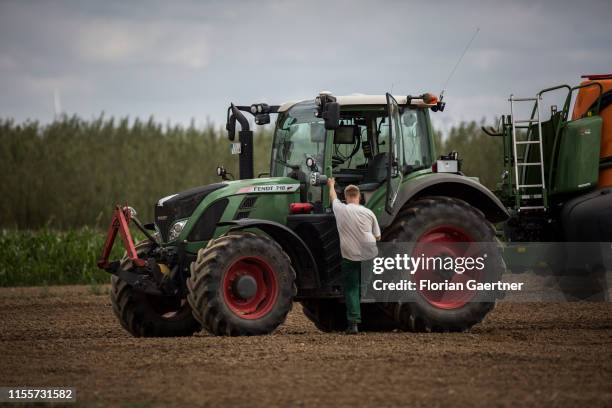 Young farmer walks to a tractor on June 28, 2019 in Koellitsch, Germany.