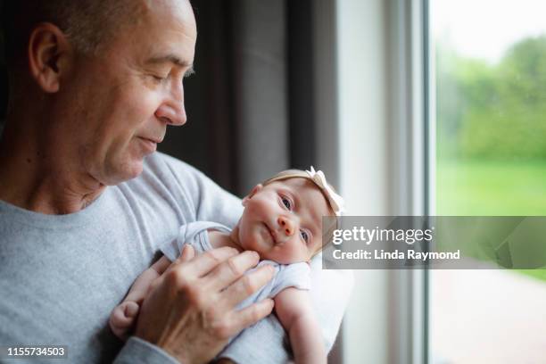 cute newborn girl with parents and grandparents - holding newborn stock pictures, royalty-free photos & images