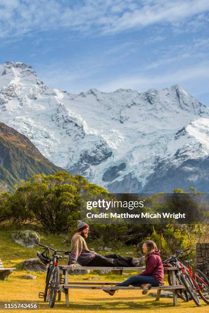 friends sit and have coffee in the mount cook national park. - mt cook stock pictures, royalty-free photos & images