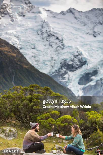 friends sit and have coffee in the mount cook national park. - mt cook national park stockfoto's en -beelden