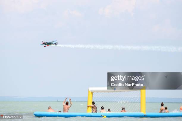 Tourists cheer as Petr Kopfstein of Check Republic, Team Spielberg competes in Masters Class Round of 14 of Red Bull Air Race World Championship at...