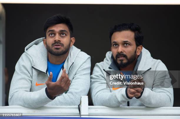 Vijay Shankar and Kedar Jadhav of India on the players balcony before the Group Stage match of the ICC Cricket World Cup 2019 between India and New...