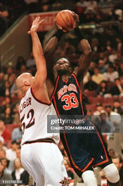 The Philadelphia 76ers Matt Geiger goes to block the shot of the New York Knicks Patrick Ewing during their 19 April game in Philadelphia. The 76ers...