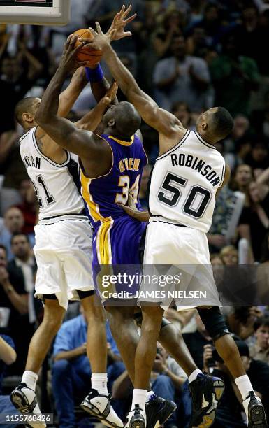 Los Angeles Lakers Shaquille O'Neal is double teamed by San Antonio Spurs Tim Duncan and David Robinson during the second half of the NBA Western...