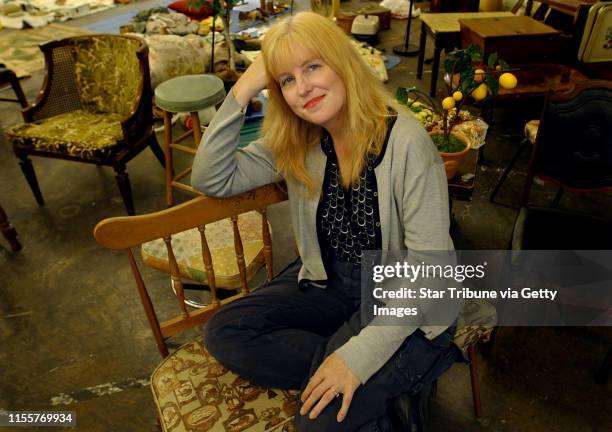 Joey McLeister/Star Tribune St. Paul, Mn.,Weds.,July 21, 2004--Eve Cauley, the set designer for "Factotum", sits among the furnishings and odds and...