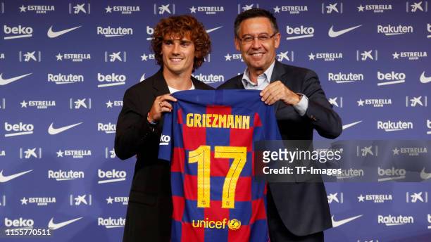 President Josep Maria Bartomeu of FC Barcelona and Antoine Griezmann of FC Barcelona present Griezmann's jersey during the press conference of FC...