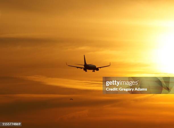flying into the sunset - sunset with jet contrails stock pictures, royalty-free photos & images