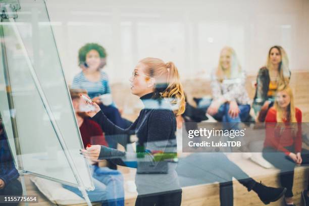 front view of business people attending a seminar in board room - social media marketing stock pictures, royalty-free photos & images