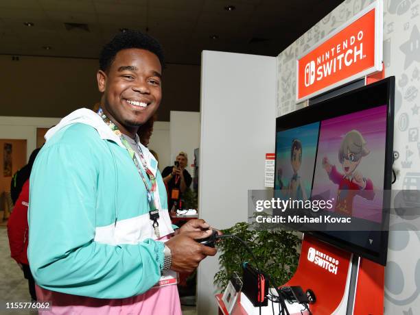 Dexter Darden checks out 'Pokémon Sword and Pokémon Shield' for the Nintendo Switch system during the 2019 E3 Gaming Convention at the Los Angeles...