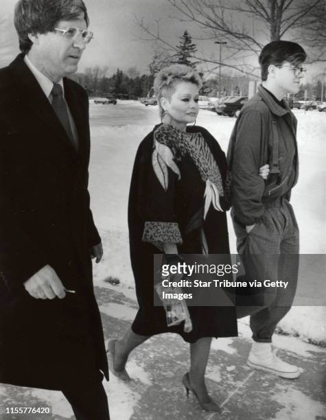 Tammy Faye Bakker holds the arm of her son Jamie Bakker as they walk to the prison in Rochester, Minnesota, to visit her husband, former...