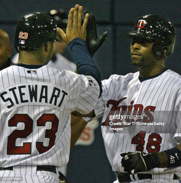 Mlevison@startribune.com 05/03/06 - Assign#102234- Twins vs. Kansas City. IN THIS PHOTO: Twins Shannon Stewart and Torii Hunter high-five at home...