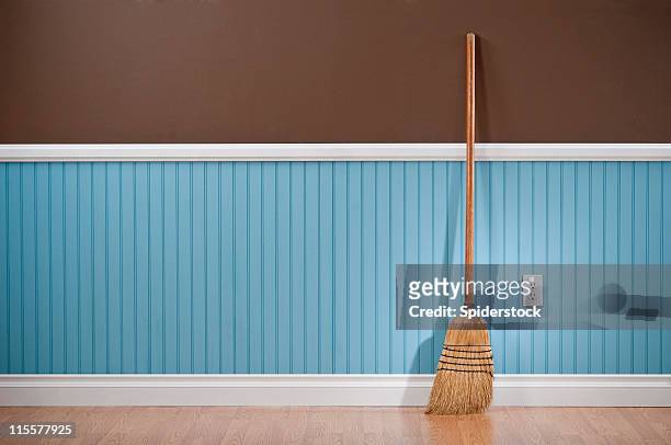 corn whisk broom standing in empty room - sweeping floor stock pictures, royalty-free photos & images