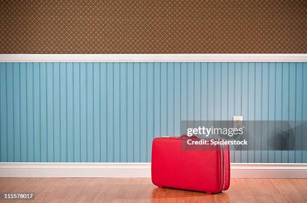 red suitcase in empty room - vintage luggage stock pictures, royalty-free photos & images