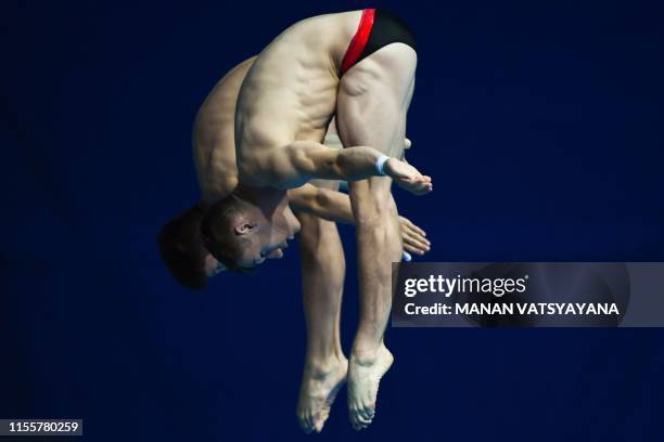 Canada's Nathan Zsombor-Murray and Canada's Vincent Riendeau compete in the men's synchronised 10m platform diving final during the 2019 World...