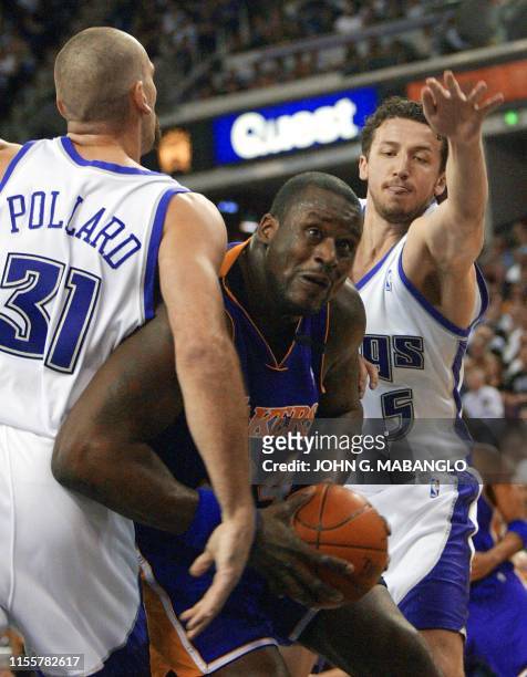 Los Angeles Lakers' center Shaquille O'Neal gets tangled between Sacramento Kings' center Scot Pollard and Kings' forward Hedo Turkoglu during the...