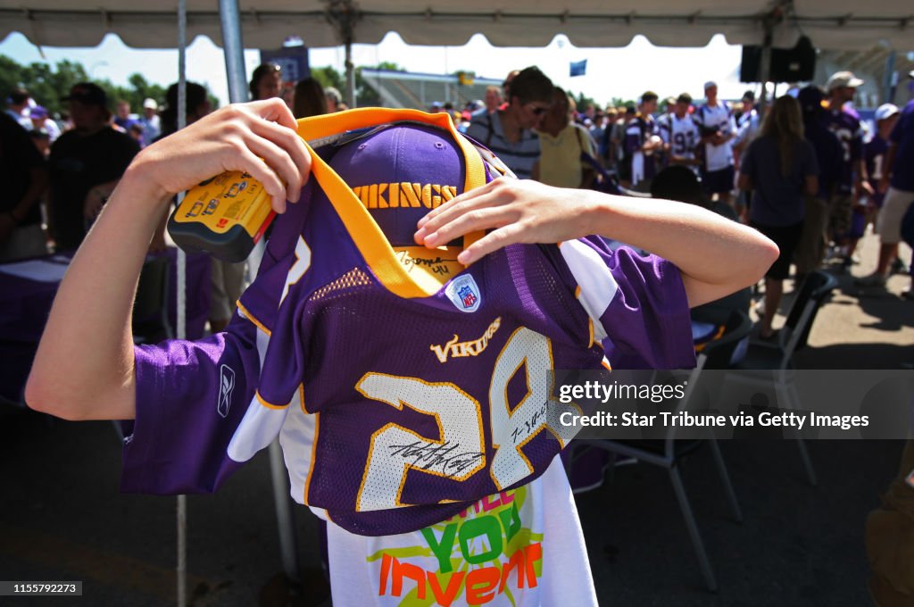 JERRY HOLT ¥jgholt@startribune.com 7/30/2007---Vikings fan Ethan Lamoine 11 of Watertown MN, had a little trouble putting on rookie Adrian Peterson autographed jersey.