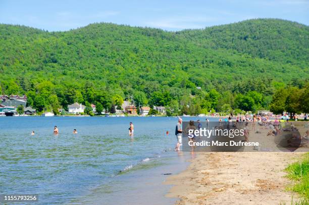 crowd on beach of lake george - lake george stock pictures, royalty-free photos & images